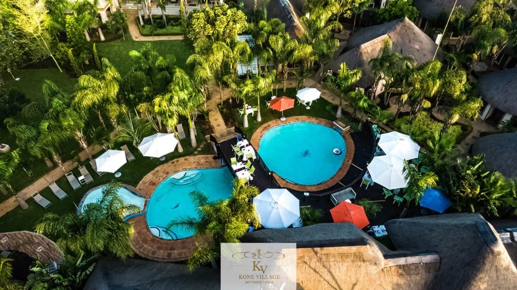 Aerial view of patio area with pool and umbrella seating arrangements.